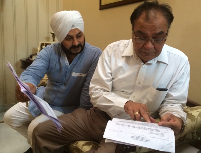 Shankar Garden's RWA President inspecting Government paperwork.